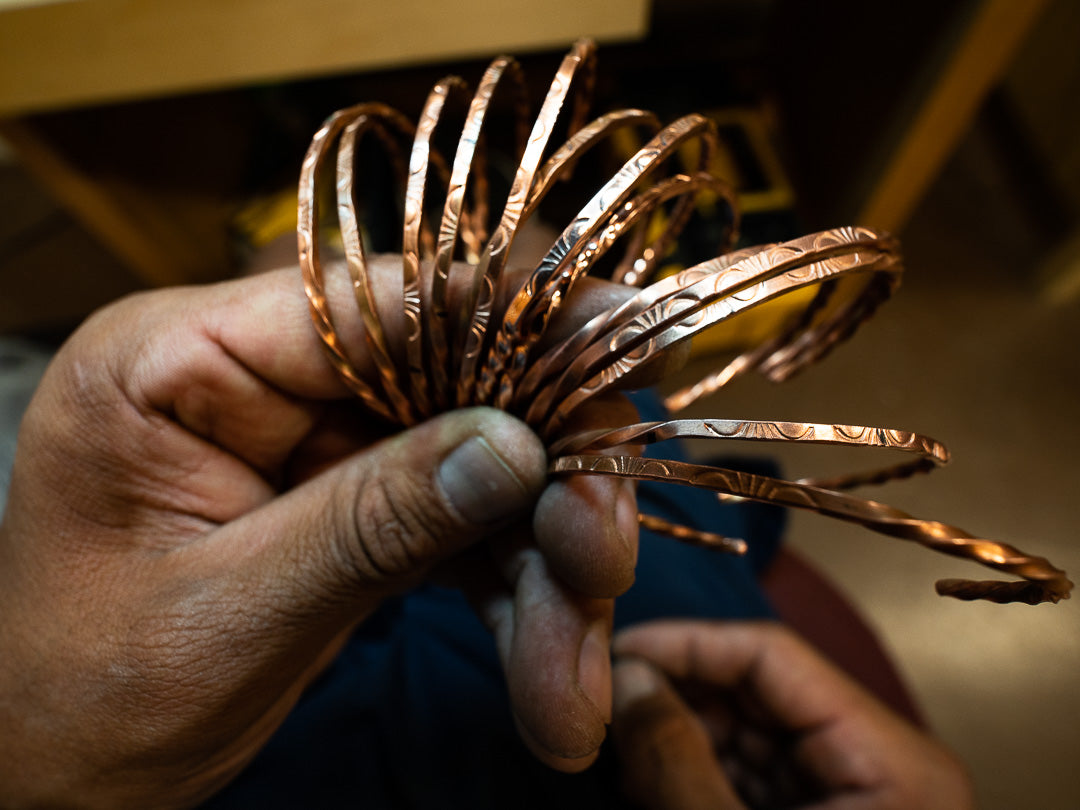 Hand-stamped copper bracelets made at the Co-Op — the thank-you gift for donations of $100 or more