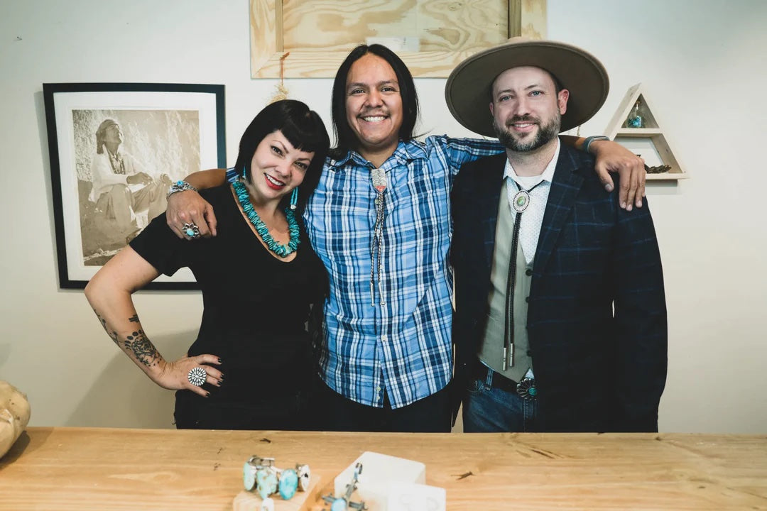 Show hosts and a guest silversmith on the Live Show set, with one-of-a-kind pieces on the table